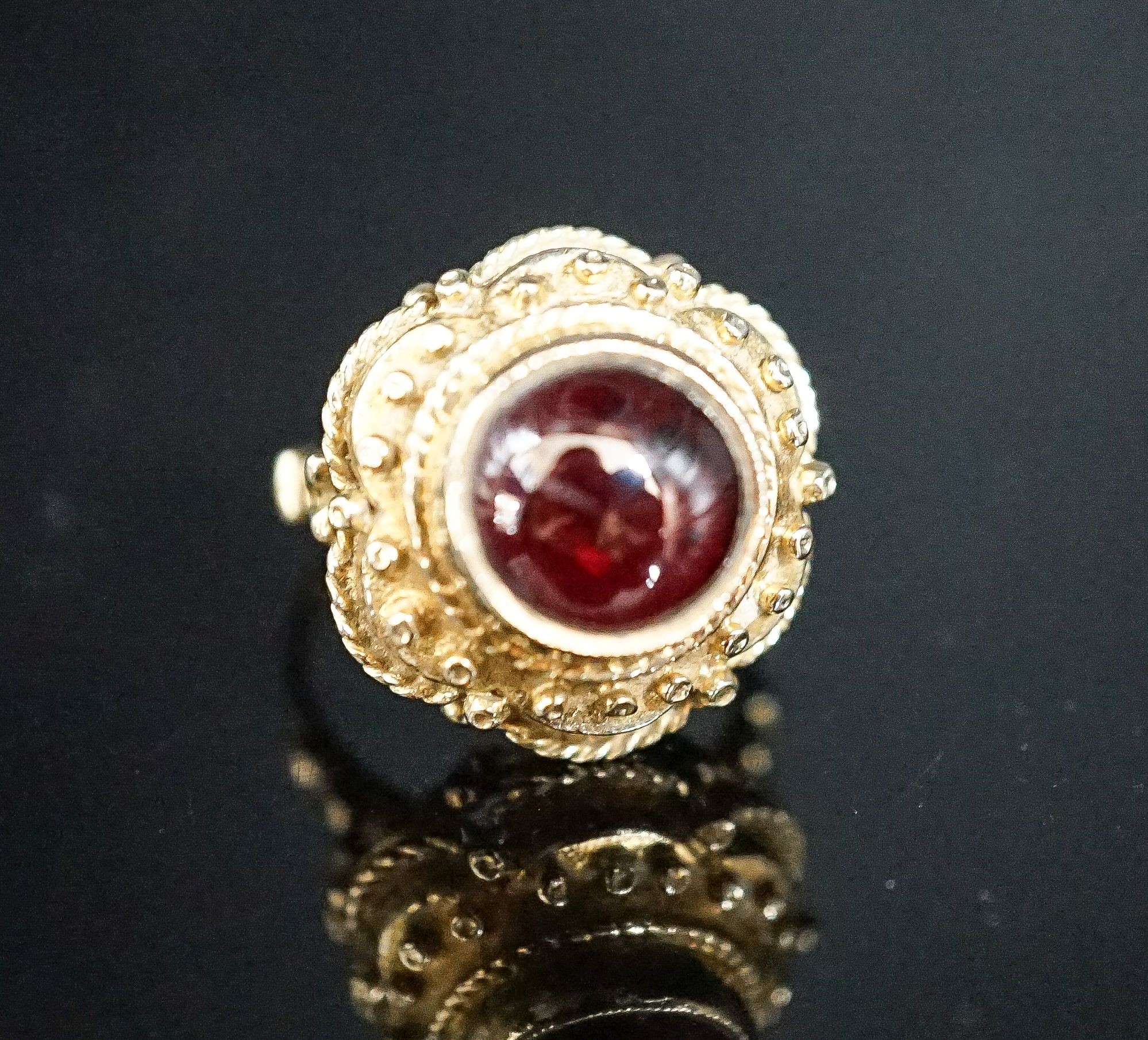 A 1960's Victorian style 9ct gold and cabochon garnet set dress ring, size I, gross 7.2 grams.